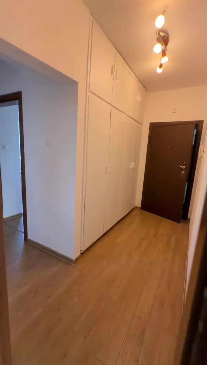 Entry hall with light-colored walls and a white built-in cabinet